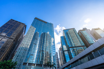Obraz na płótnie Canvas up view of modern glass building in hongkong china