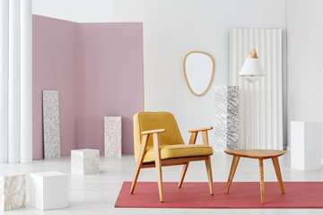 Mustard armchair by table