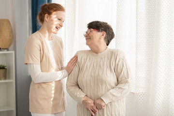 Smiling nurse and elderly woman