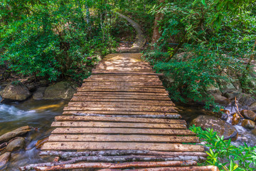 Wooden bridge over the waterfall