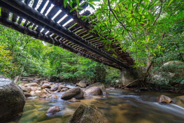 Wooden bridge over the waterfall