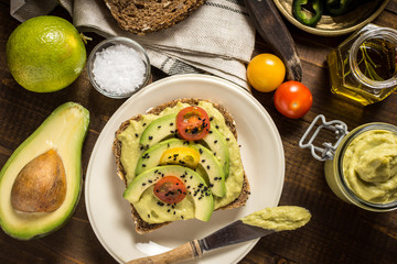 Avocado Spread Guacamole and Slices with Fresh Cherry Tomato and Black Sesame. Healthy Breakfast Concept.