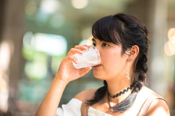 Asian teenage girl drinking water