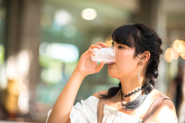Asian teenage girl drinking water