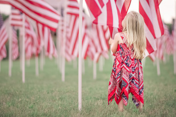 Girl honoring Flags for Independence Day