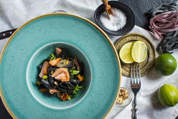 Black Pasta Spaghetti from Squid Ink with Salmon and Vegetables