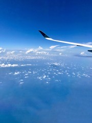 Naklejka na ściany i meble This photo was taken on the flight from Hong Kong to Singapore in April 2017. The feeling above the cloud in the sky is amazing and I enjoy it.