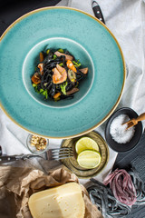 Black Pasta Spaghetti from Squid Ink with Salmon and Vegetables
