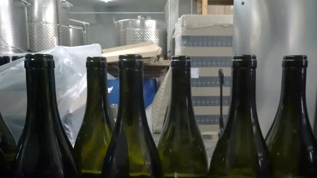 Bottling and sealing conveyor line at winery factory