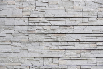Modern brick wall, slab stone pattern as background.
