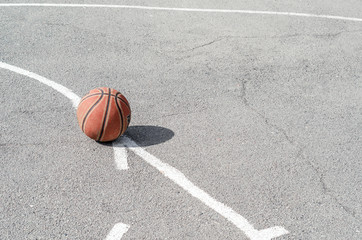 Fototapeta premium ball for playing basketball lies on the sports ground