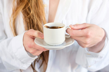 Redhead white girl in white shirt drinking coffee, close up