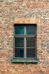 Fototapeta na wymiar a window in a brick old house close up