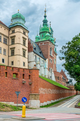 Fototapeta na wymiar Krakow, Poland - August 13, 2017: Krakow, high brick tower - Wawel Castle on blue sky background