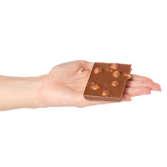 Chocolate with whole hazelnuts in hand on a white background isolation