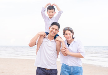 portrait happy family outdoors on a beach smiling