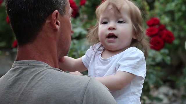 Father dances with his little daughter. A man and happy smiling little girl