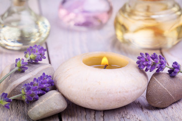 Massage oils, lavender flowers and scented candle