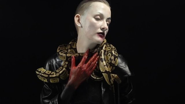 Woman in horror image with two snakes