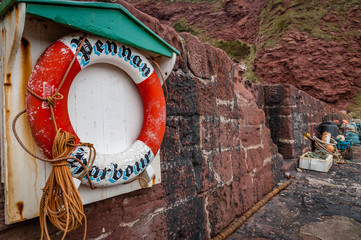 Lifebuoy and fishing gear at Pennan harbour in Aberdeenshire,Scotland.