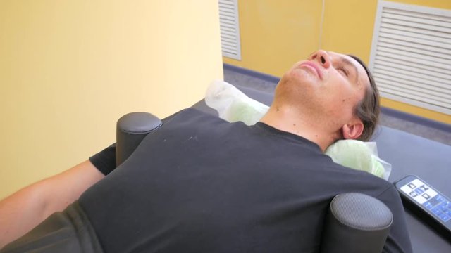 patient on treatment of intervertebral discs and spinal hernia, stretching spine on special medical machine tool. Modern physical therapy, health care concept