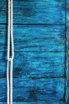 White rope on wooden deep blue board background vertical