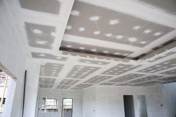 ceiling gypsum board installation at construction site - obrazy, fototapety, plakaty