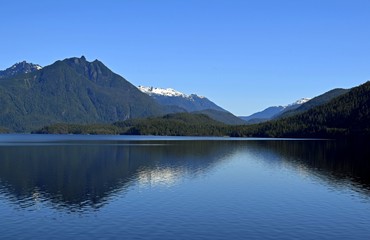 view across the Kennedy Lake, towards the mountains of the Clayoquot Plateau on Vancouver Island, British Columbia Canada