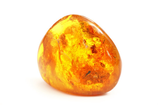 Amber. Transparent beautiful and bright piece of yellow amber amber on a white background. A sunny stone with a bright light inside. Natural material for jewelers. Sun Stone. Frozen resin