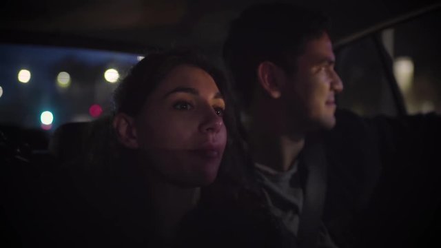 Cute Couple Enjoy City Sights From Back Seat Of Moving Car In Downtown Los Angeles, Slow Motion