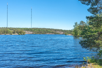 A beautiful forest lake in Nacka Nature Reserve, Sweden. In the background, two masters with...
