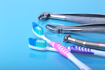 dental care toothbrush with dentist tools on mirror background
