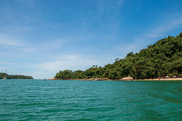 View of beach, sea and forest on sunny day in Ilha do Pelado, a tropical beach near Paraty, an amazing and historic town totally preserved in the Rio de Janeiro State, southwestern Brazil