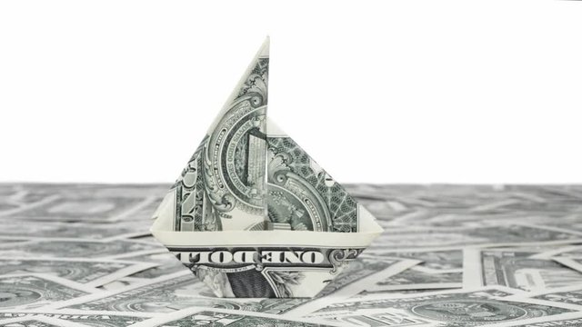 Investment concept. Ship origami mafe of dollars