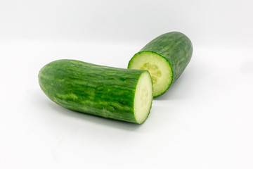 A cucumber cut in half, against a white background