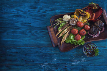 Grilled vegetable on a blue wooden background