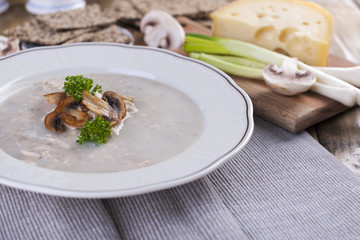 Mushroom cream soup on white wooden board. top view. cipy space.
