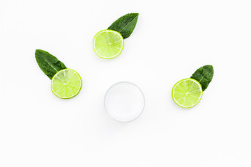 Organic citrus cosmetics for skin care. Lemon or lime moisturising cream on white background top view copy space