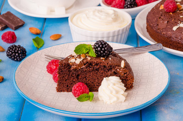 Chocolate cake brownie with raspberries, blackberries, almonds and whipped cream