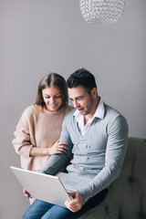 Happy couple looking at laptop.