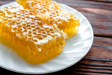 honey in honeycombs on a white plate 