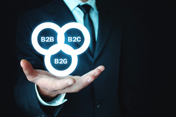 Businessman holding B2B, B2C, B2G business models. Business concept