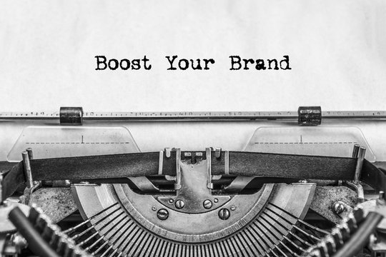 Boost Your Brand text is typed not by a vintage typewriter, old paper, close-up