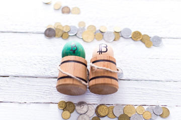 Egg with bitcoin in a wooden small barrel