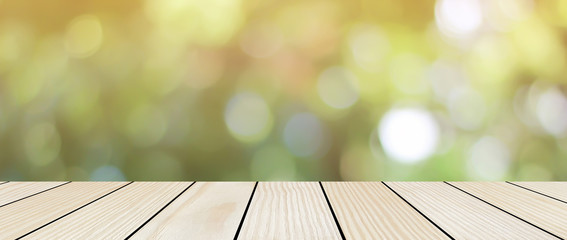 blur nature background with glow sunny light and aged plain wood table top perspective view for...