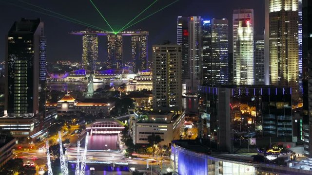  Elevated illuminated view over the Entertainment district of Clarke Quay, the Singapore river and City Skyline, South East Asia, Time lapse