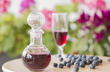 A bottle of Homemade blueberries liqueur.