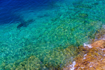 Naklejka na ściany i meble Crystal clear blue sea with rocks on the bottom, Gran Canaria, Canary Islands, Spain