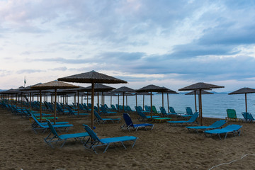 Empty sunbeds beach in evening; Athens area, Greece