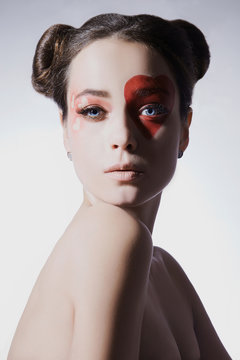 Beautiful woman with heart make-up